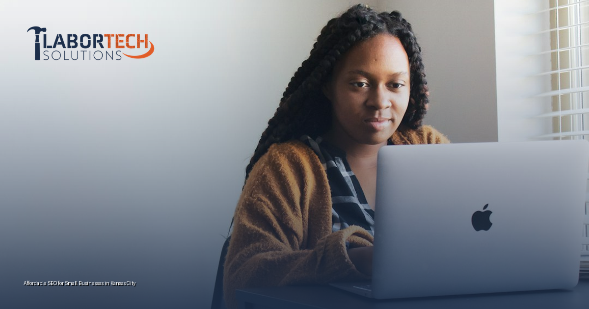 Kansas City small business owner reviewing SEO reporting on a laptop